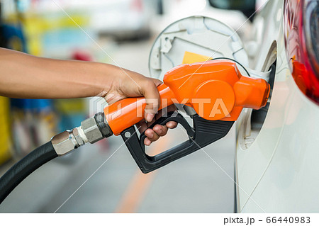 Man Refill and filling Oil Gas Fuel at station. 66440983