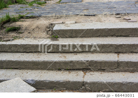 Broken concrete steps on sidewalk in summer street Broken concrete steps on sidewalk in summer street 66443031