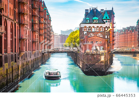 Hamburg Speicherstadt warehouse district with sightseeing tour boat on a sunny day in summer, Hamburg, Germany 66445353
