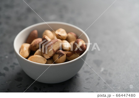 Brazil nuts in white bowl on concrete background with copy space Brazil nuts in white bowl on concrete background with copy space 66447480
