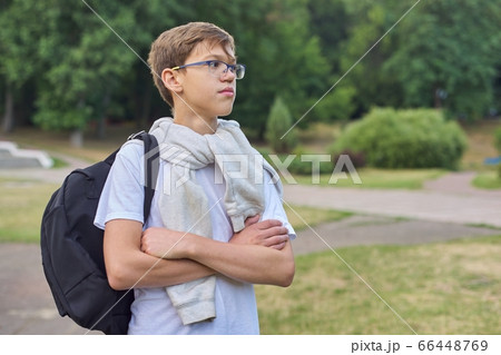 Outdoor portrait of teenager schoolboy with glasses backpack Outdoor portrait of teenager schoolboy with glasses backpack 66448769