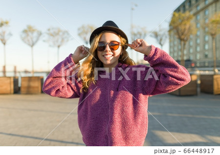 Outdoor portrait of smiling teen girl 13, 14 years old 66448917