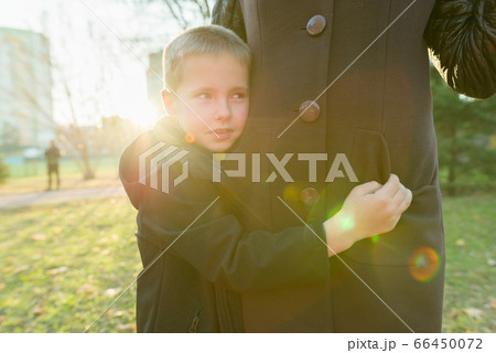 Little son hugging his mother, boy smiling sunny day 66450072