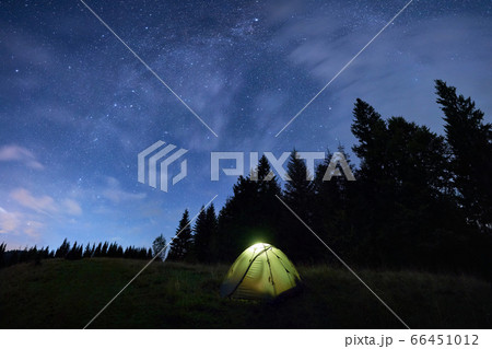 Magical starry night at a campsite in the mountains during summer time Magical starry night at a campsite in the mountains during summer time 66451012