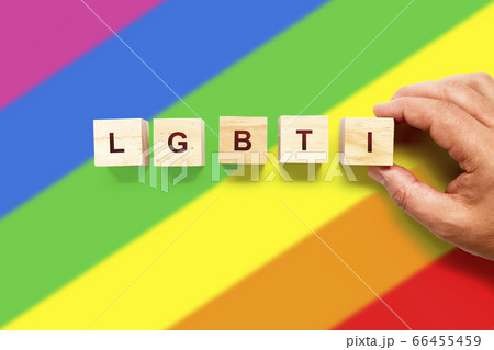 Person forming the word LGBTI with wood on a 66455459