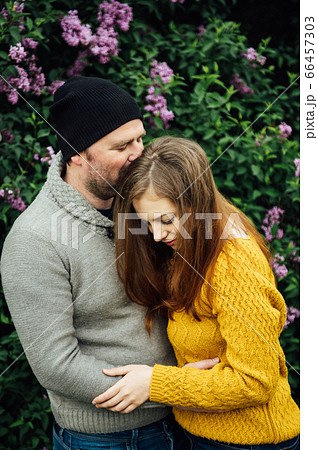 Beautiful couple in love is hugging near a lilac bush. lifestyle photo 66457303