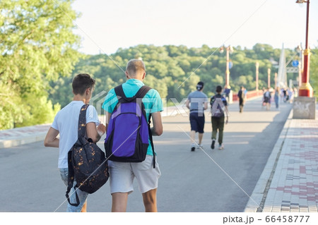 Lifestyle of young males, teenagers with backpacks walking their backs 66458777