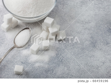 Glass bowl of natural white refined sugar with Glass bowl of natural white refined sugar with 66459196