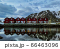 A symmetric row of classic red rorbu in Ballstad, Lofoten island, Norway 66463096