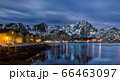 Classic illuminated yellow waterfront rorbu in Ballstad, Lofoten island, Norway 66463097