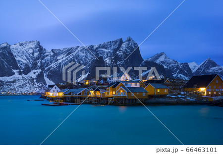 Classic illuminated yellow waterfront rorbu in Reine, Lofoten island, Norway Classic illuminated yellow waterfront rorbu in Reine, Lofoten island, Norway 66463101