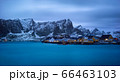 Classic illuminated yellow waterfront rorbu in Reine, Lofoten island, Norway 66463103