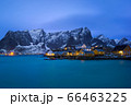 Classic illuminated yellow waterfront rorbu in Reine, Lofoten island, Norway 66463225