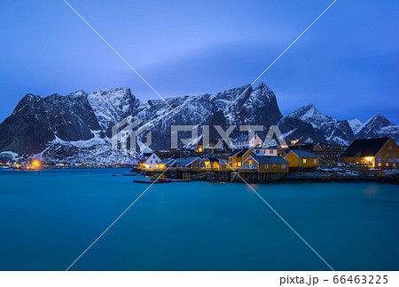 Classic illuminated yellow waterfront rorbu in Reine, Lofoten island, Norway Classic illuminated yellow waterfront rorbu in Reine, Lofoten island, Norway 66463225