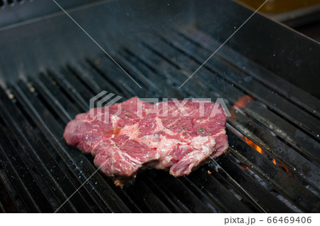 Juicy ribeye steak with spices. Cooking in a 66469406