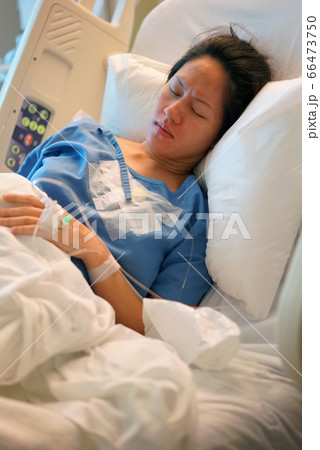 Asian Chinese Woman patient lying in the hospital 66473750