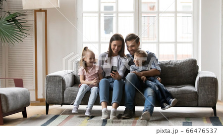 Happy family with children having fun with smartphone 66476537