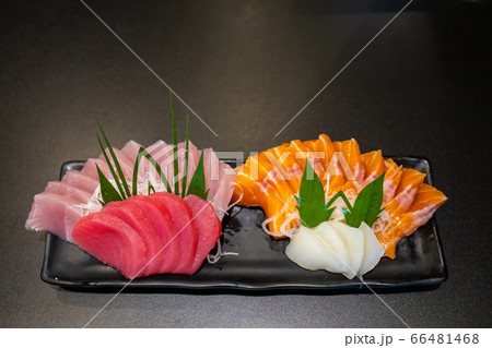 Close up fresh raw sasimi fish set  in a black dish on black table. 66481468