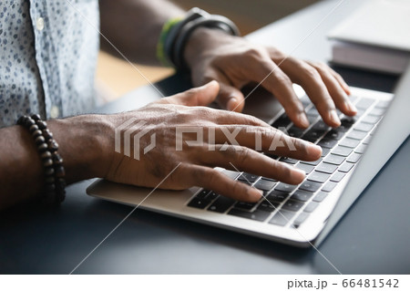 Closeup image african male hands typing on laptop keyboard Closeup image african male hands typing on laptop keyboard 66481542