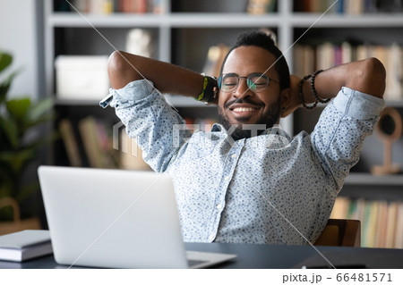 African guy put hands behind head takes break watching movie African guy put hands behind head takes break watching movie 66481571