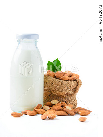 Bottle of milk and Almonds nuts with leaf isolated Bottle of milk and Almonds nuts with leaf isolated 66482073