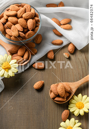 Almonds nuts peeled on wood spoon on wood table Almonds nuts peeled on wood spoon on wood table 66482074