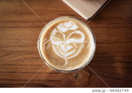 A cup of coffee with latte art on top 66482749