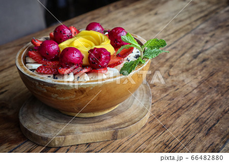 Smoothie bowl decorated with mango, strawberry, 66482880