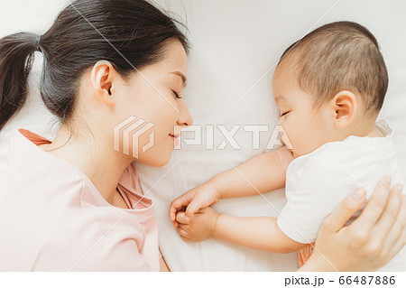 Mother and son sleeping on bed Mother and son sleeping on bed 66487886