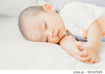 A child sleeping on bed A child sleeping on bed 66487888