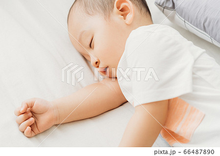 A child sleeping on bed 66487890