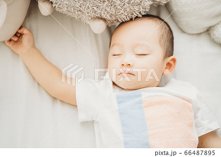 A child sleeping on bed 66487895