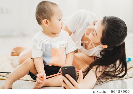Mother and son playing on the floor 66487900