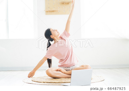 A woman doing yoga at home A woman doing yoga at home 66487925