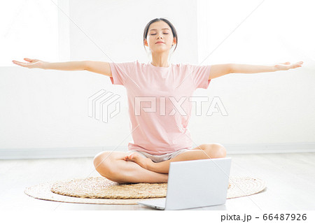 A woman doing yoga at home A woman doing yoga at home 66487926