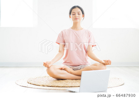 A woman doing yoga at home A woman doing yoga at home 66487930