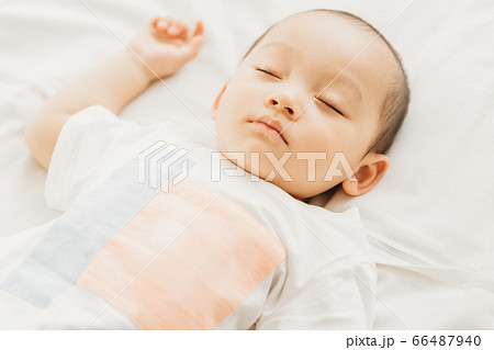 A little boy sleeping on the bed 66487940