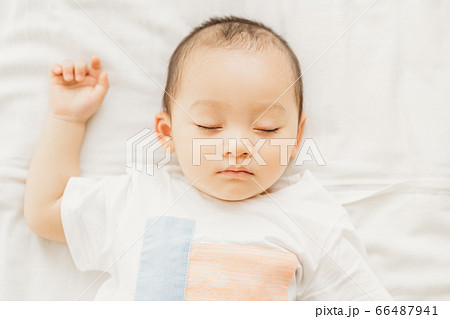 A little boy sleeping on the bed 66487941