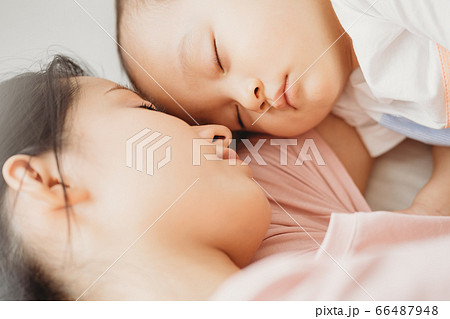 Mother and son sleeping on the bed 66487948