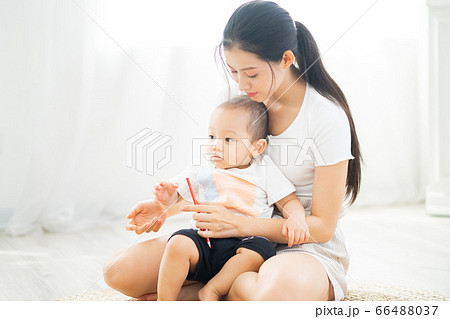 Mother and son playing on the floor 66488037