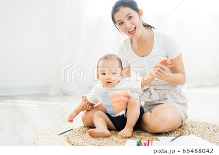 Mother and son playing on the floor Mother and son playing on the floor 66488042
