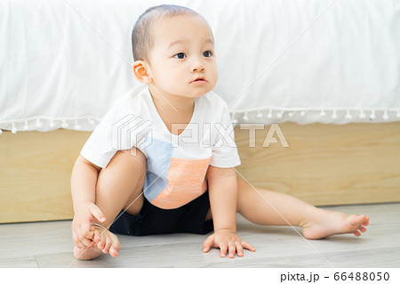 A child playing on the floor 66488050
