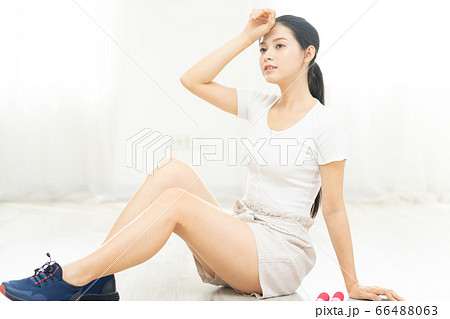 Beautiful woman doing exercise at home Beautiful woman doing exercise at home 66488063