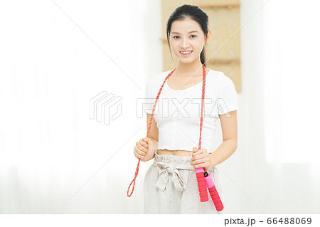 Beautiful woman doing exercise at home 66488069