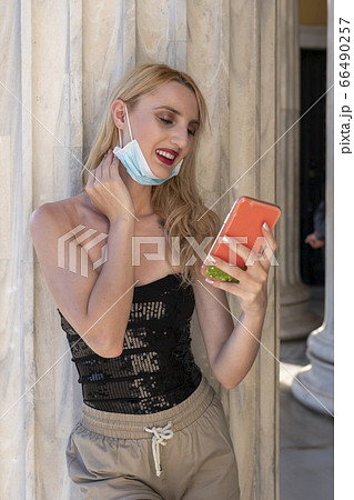 beautiful blond girl smiling with face mask after lock down reopening beautiful blond girl smiling with face mask after lock down reopening 66490257