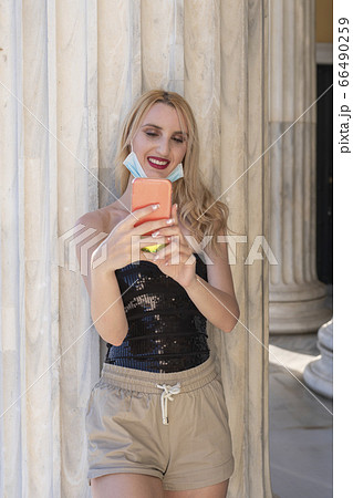 beautiful blond girl smiling with face mask after lock down reopening beautiful blond girl smiling with face mask after lock down reopening 66490259