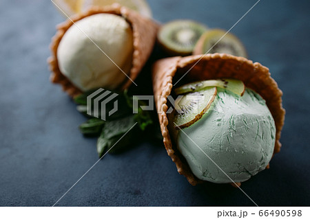 Waffle cones with exotic lemon and kiwi ice-cream 66490598
