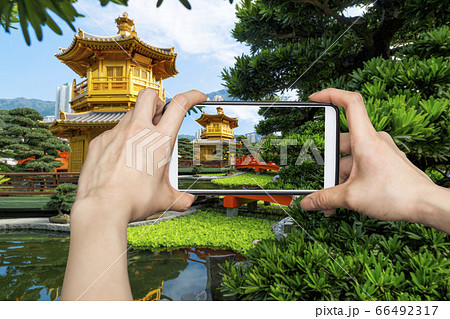 Girl taking pictures on mobile smart phone in 66492317