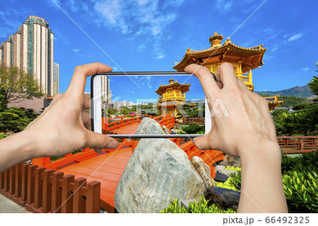 Girl taking pictures on mobile smart phone in 66492325