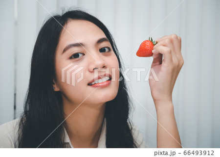 Woman eat strawberry red berry fruit sweet juicy Woman eat strawberry red berry fruit sweet juicy 66493912